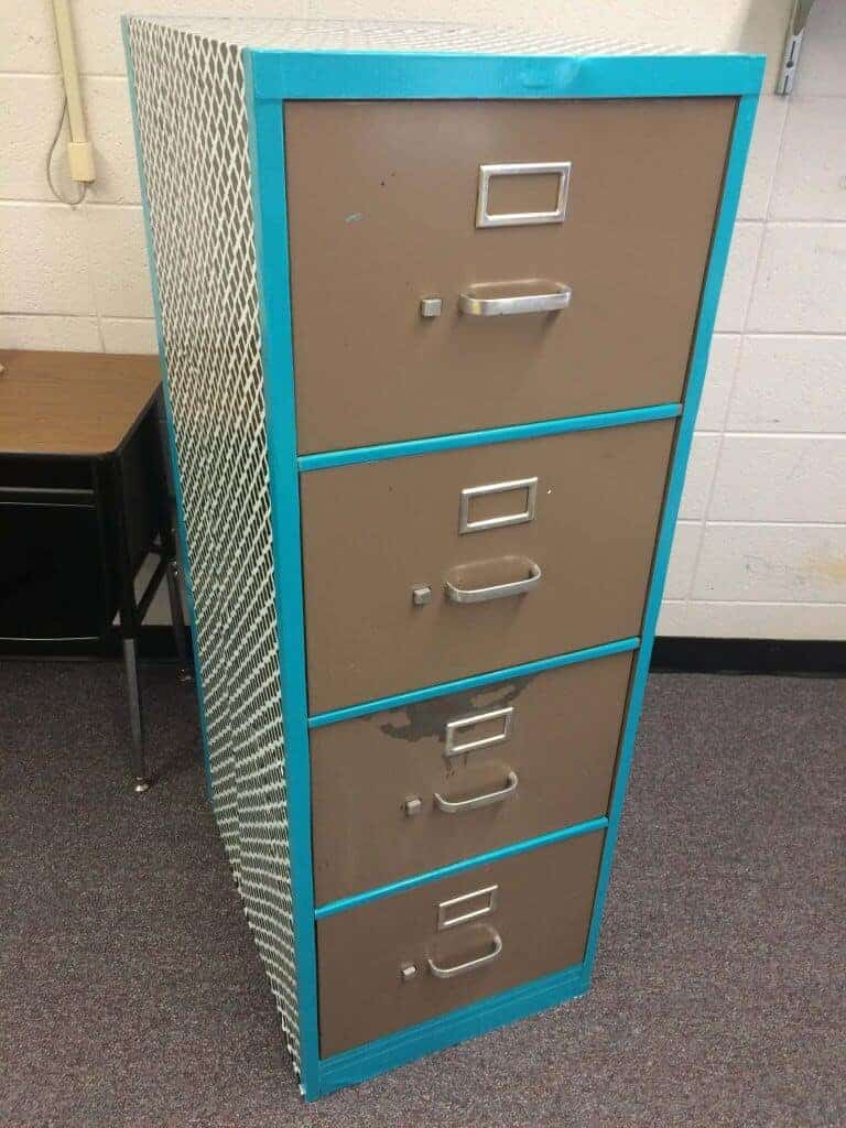 This is the middle stage of the filing cabinet makeover. Cover the cabinet with contact paper and the cover the edges with colored duct tape.